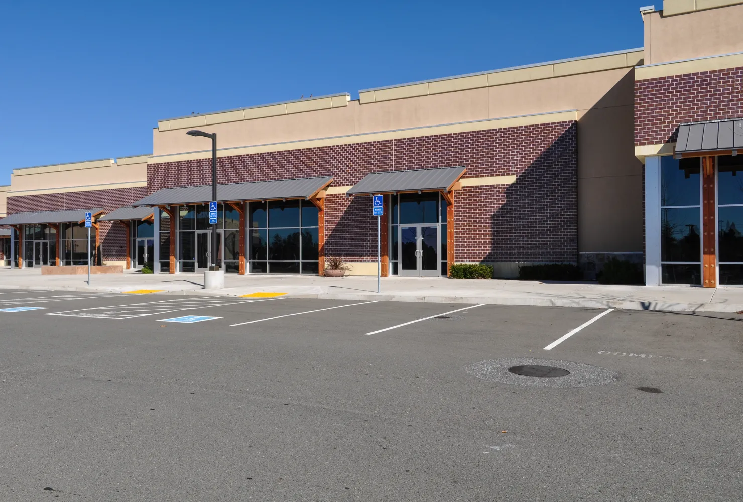 Retail plaza exterior painting project with brick and stucco finishes by Best Painting LA in Los Angeles, CA