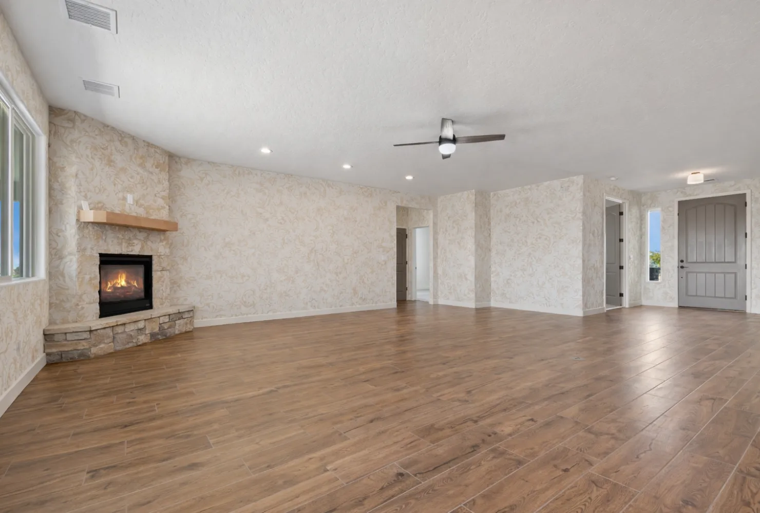 Living room wallpaper installation project featuring accent walls and fireplace by Best Painting LA in Los Angeles, CA