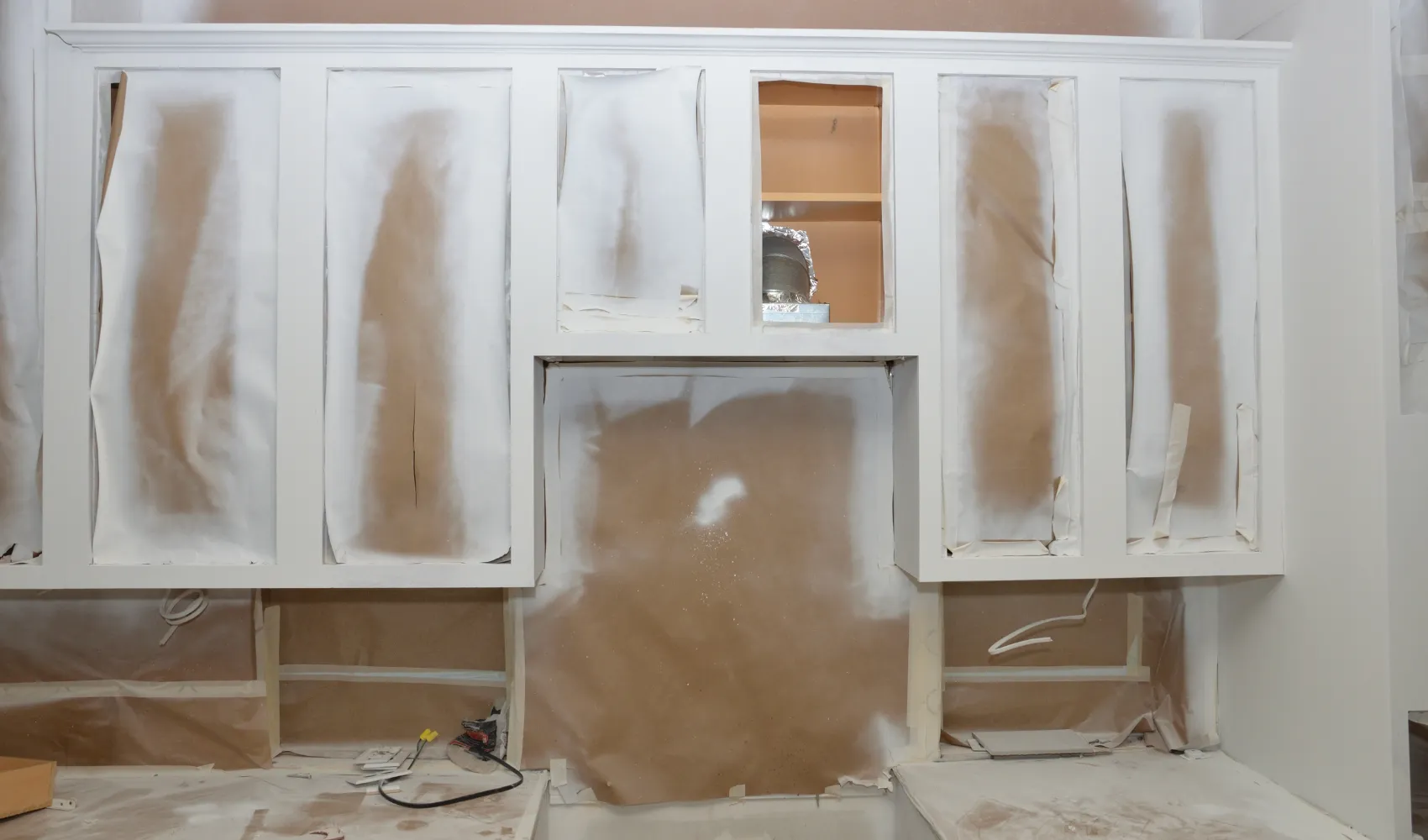 Kitchen cabinet painting preparation with professional masking and surface protection before repainting in Los Angeles.