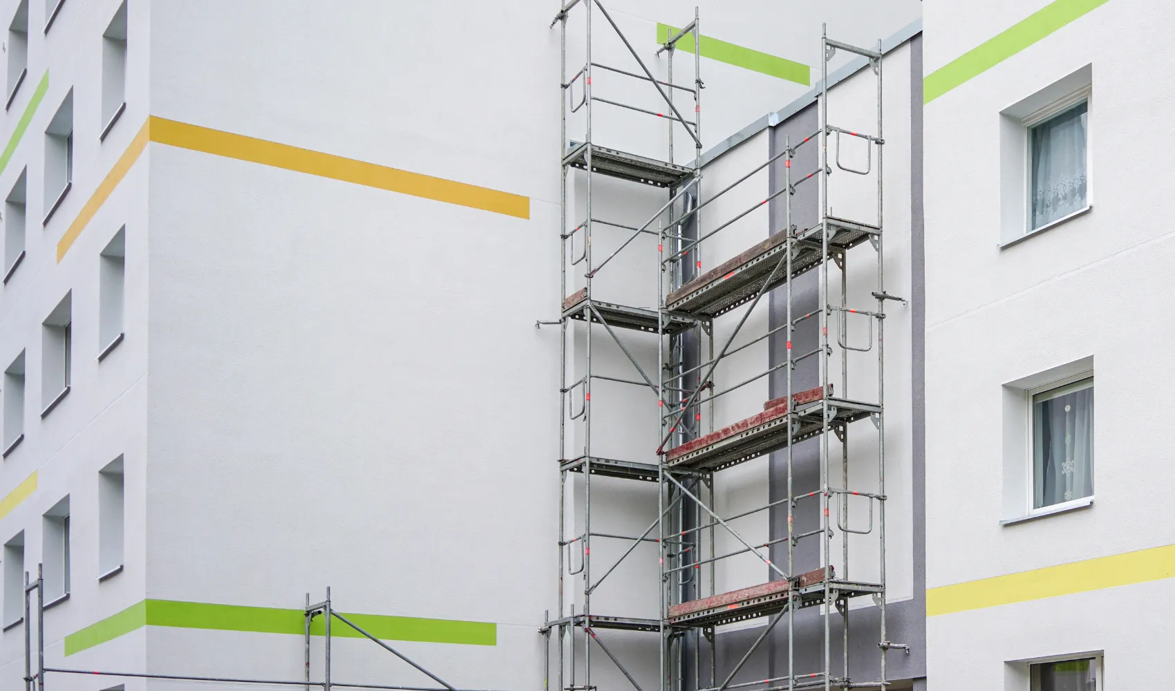 Commercial exterior painting project using scaffolding on a multi-story building in Los Angeles, CA