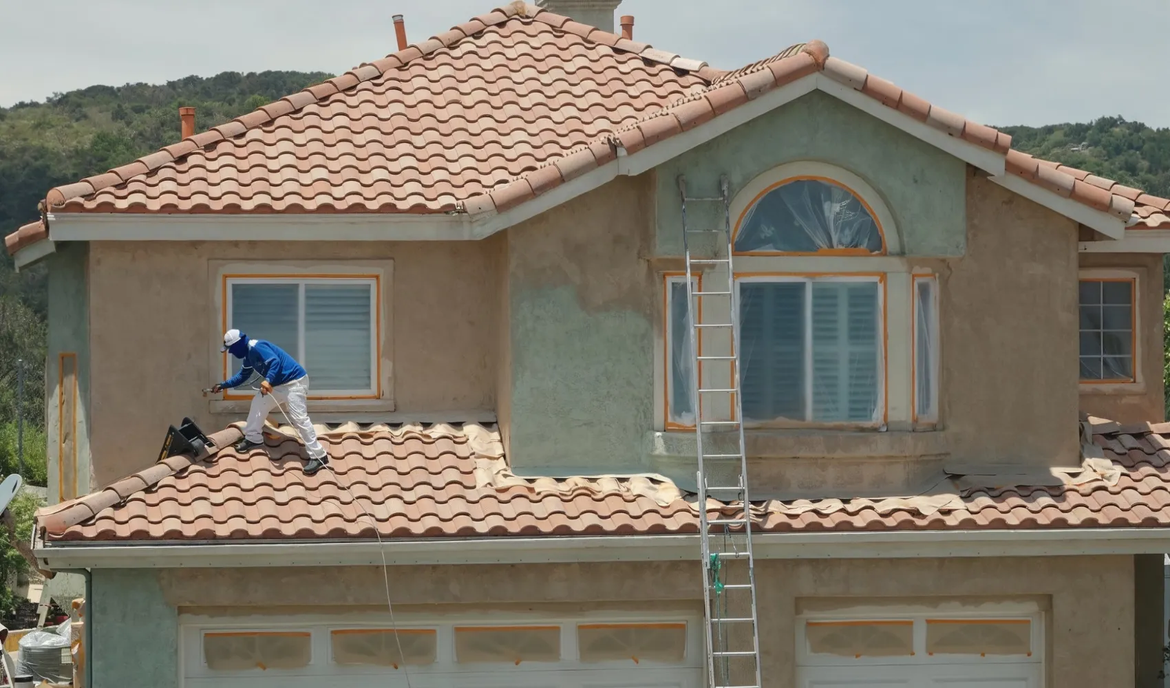 Residential interior painting service showing professional painter detailing window trim with precision